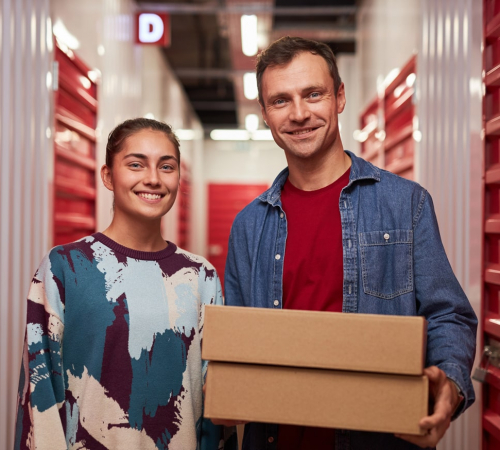 happy-couple-standing-in-corridor-of-self-storage-facility-unit happy-couple-standing-in-corridor-of-self-storage-facility-unit